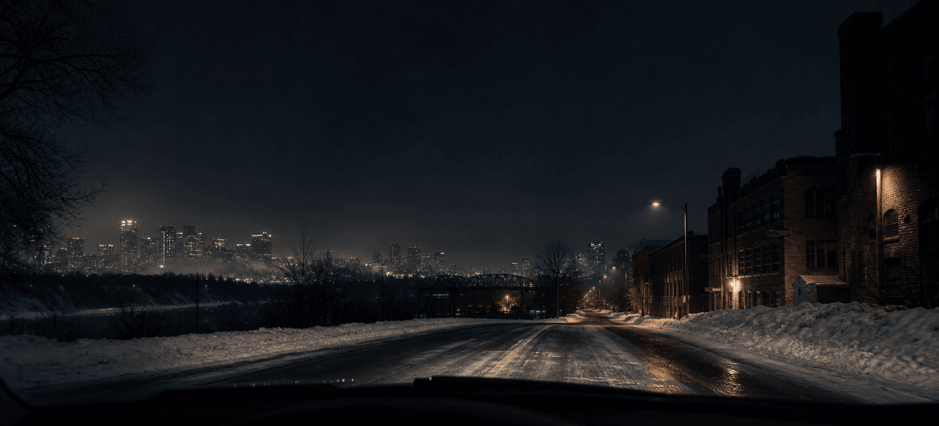 Dark road outside Edmonton at night, lit by headlights
